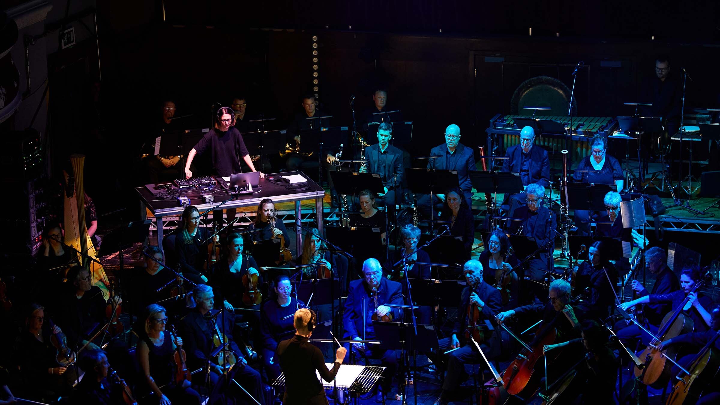 Artist playing synth with orchestra Artist playing synth with orchestra