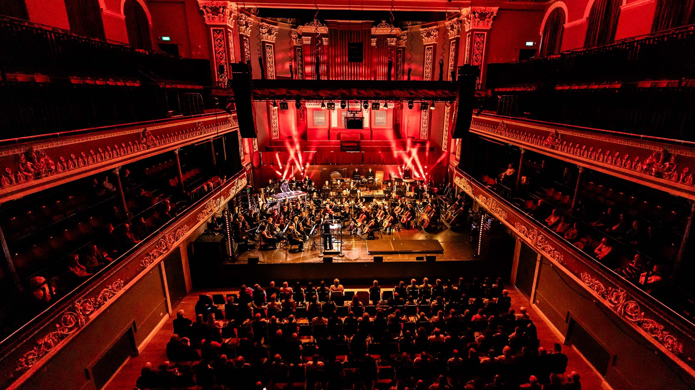 Venue with orchestra and crowd Venue with orchestra and crowd